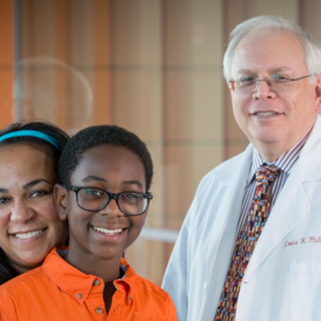 Picture of doctor with 2 patients - mother and son 